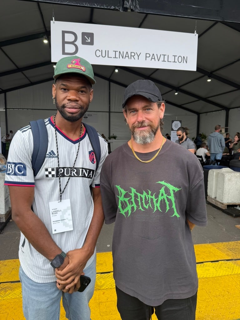 Lordell at a Block event, standing with Jack Dorsey outside the culinary pavilion